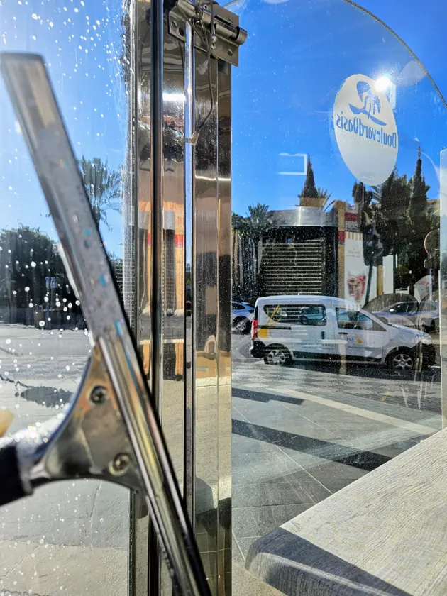 Commercial glass door cleaned with a professional squeegee